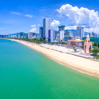 Aerial view of Nga Trang beach, with white sand and a view of the city buildings