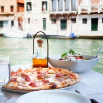 Pizza at a restaurant in Italy overlooking a canal in Venice