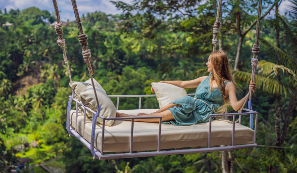 A lady swinging on a bed swing in Ubud