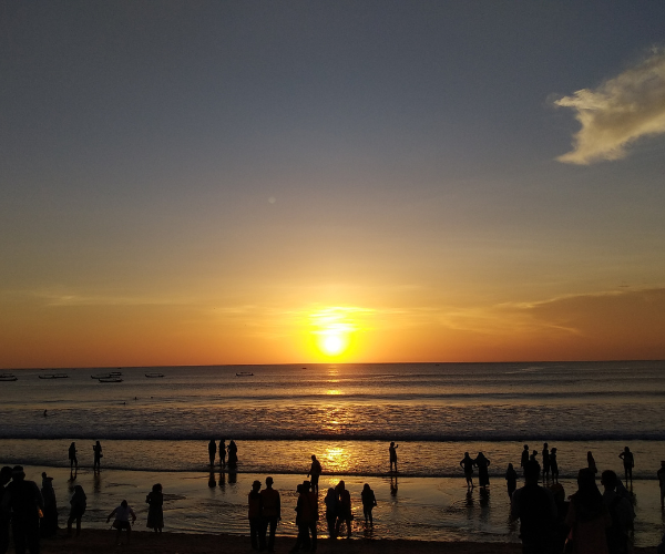 Many people on Kuta beach watching the sun set